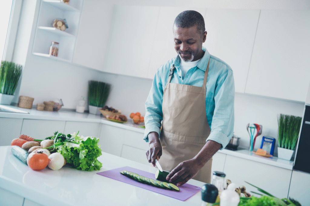 man in his 50's cooking in his kitchen