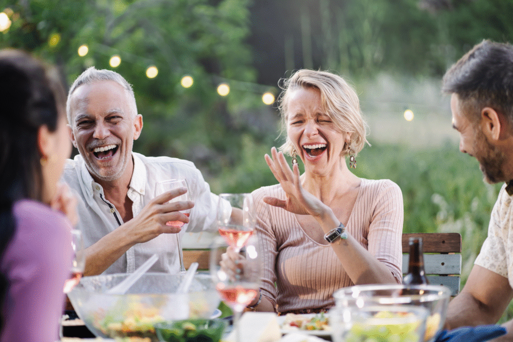 50 something man and woman laughing at backyard party