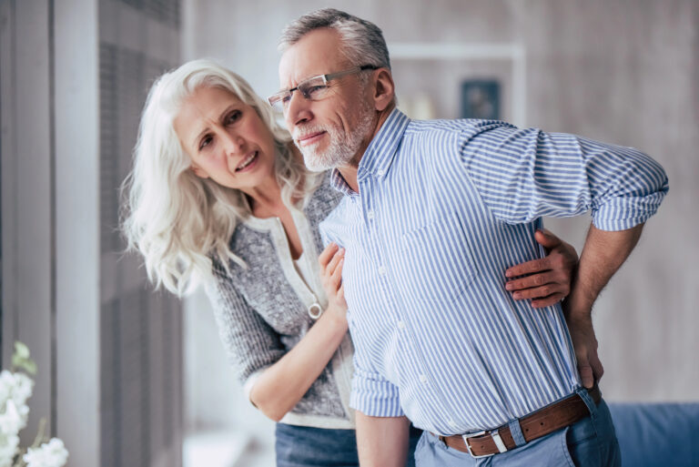 5 Reasons Why This Online Program Is Our #1 Choice for Permanent Back Pain Relief mature couple wiht man in back pain
