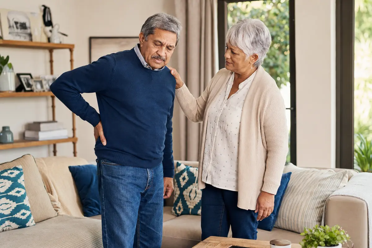Older couple coping with chronic lower-back pain at home