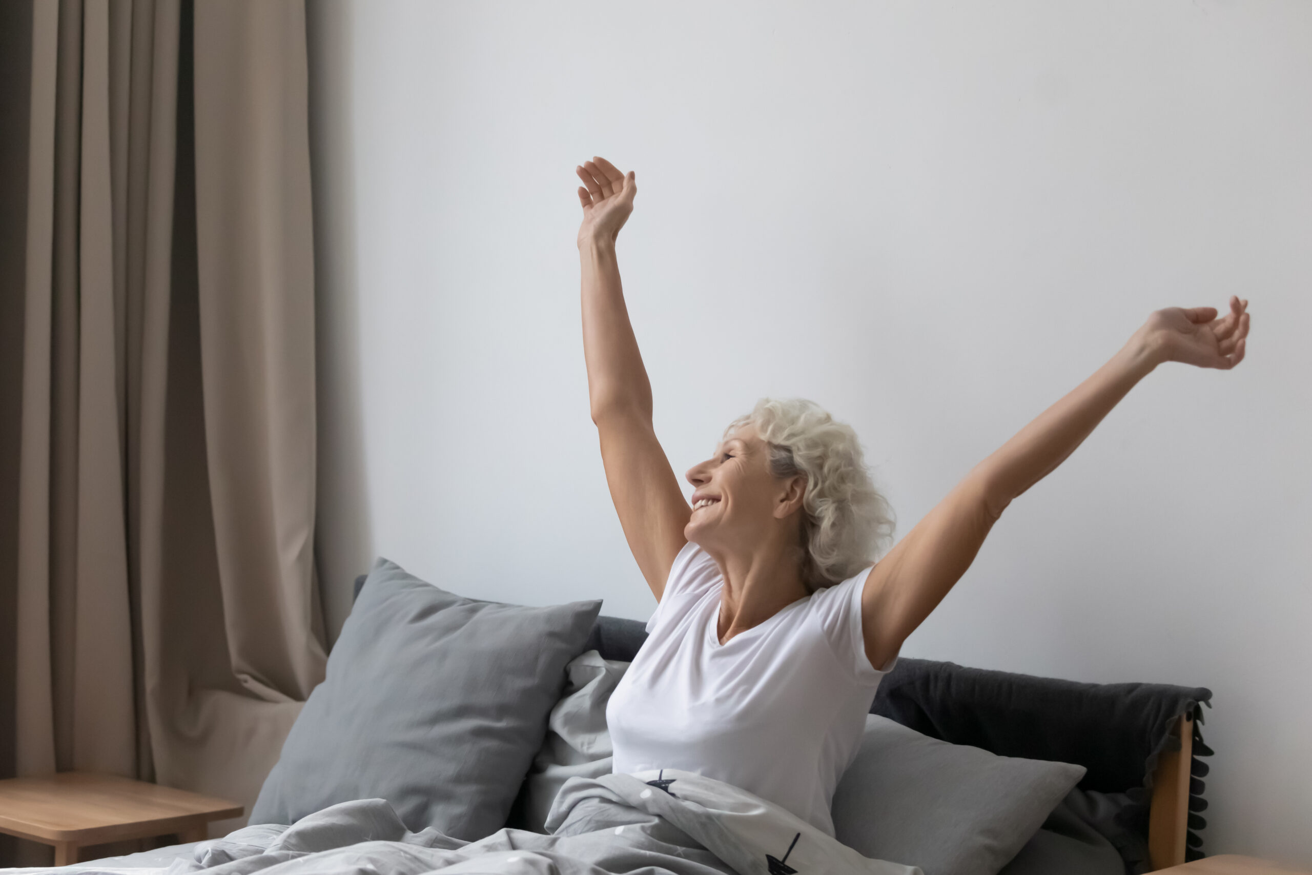 Senior woman waking up in the morning refreshed