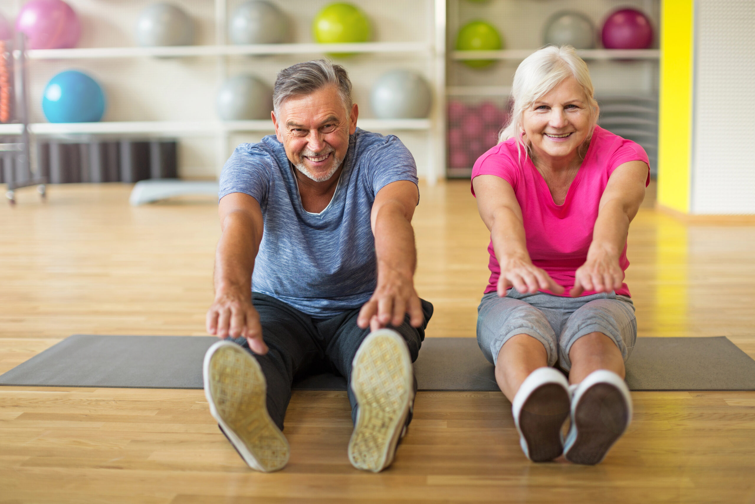 mature couple back in the gym after 50 stretching 
