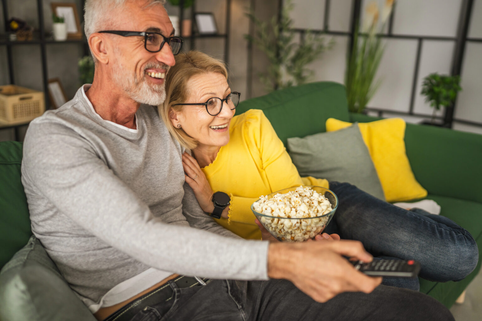 Mature man and woman watching movie together