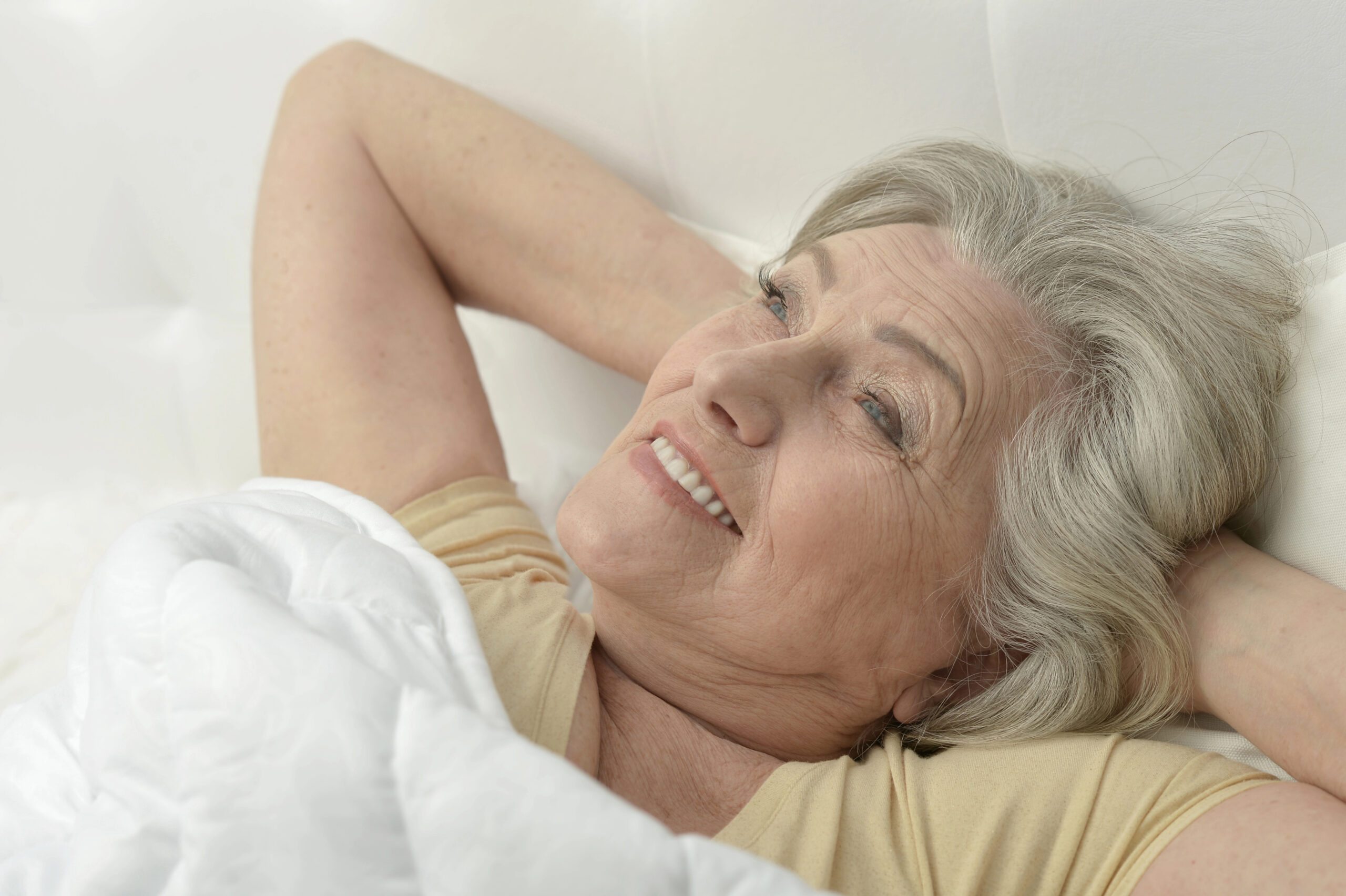 mature woman waking up refreshed in the morning